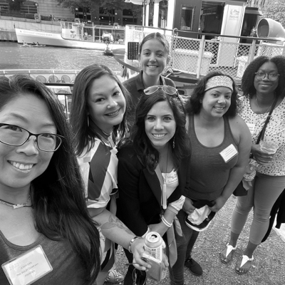 Black and white photo of a group of six women taking a selfie, waiting to board the boat.